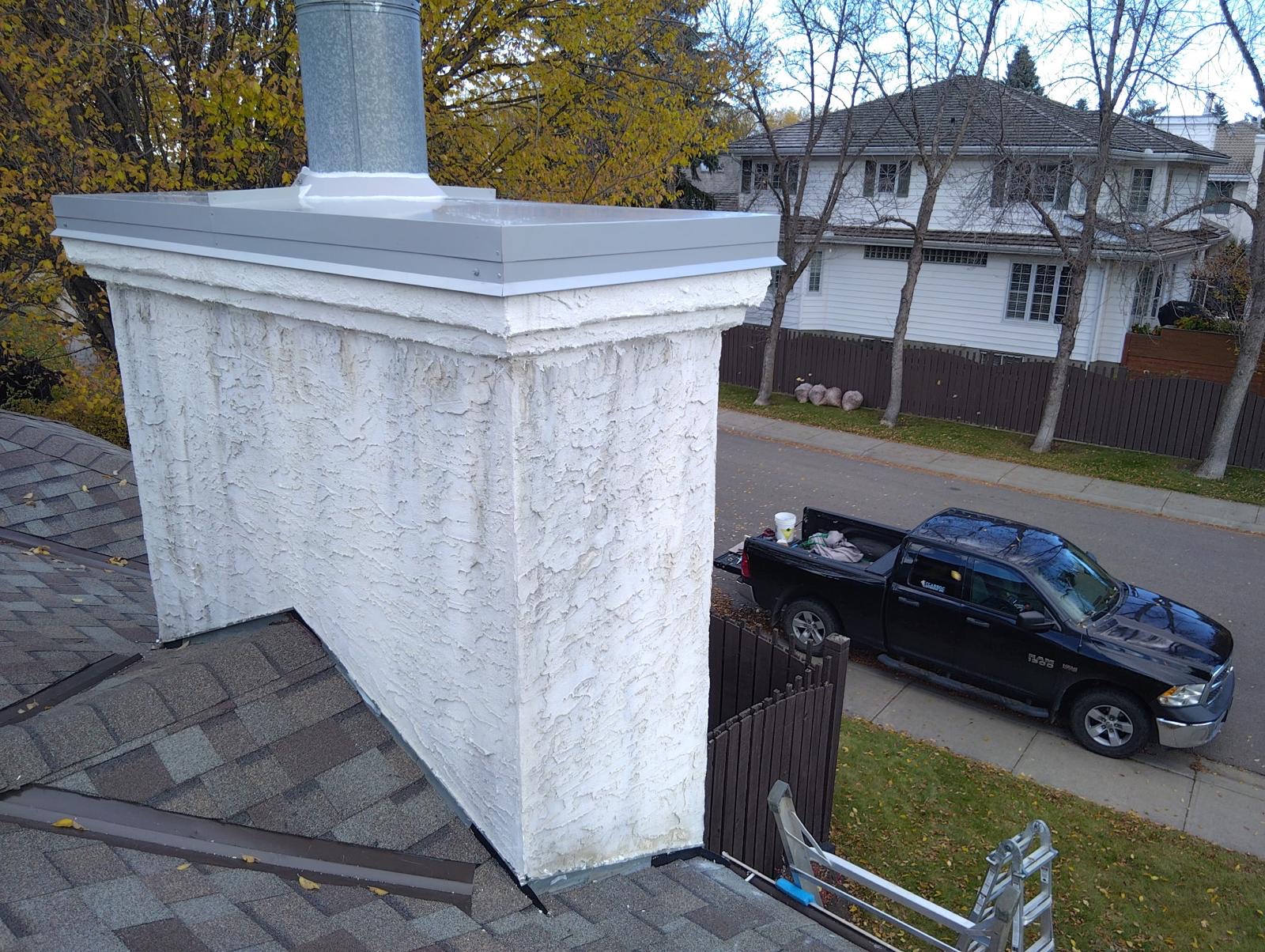 Completed stucco chimney with custom metal chase cover