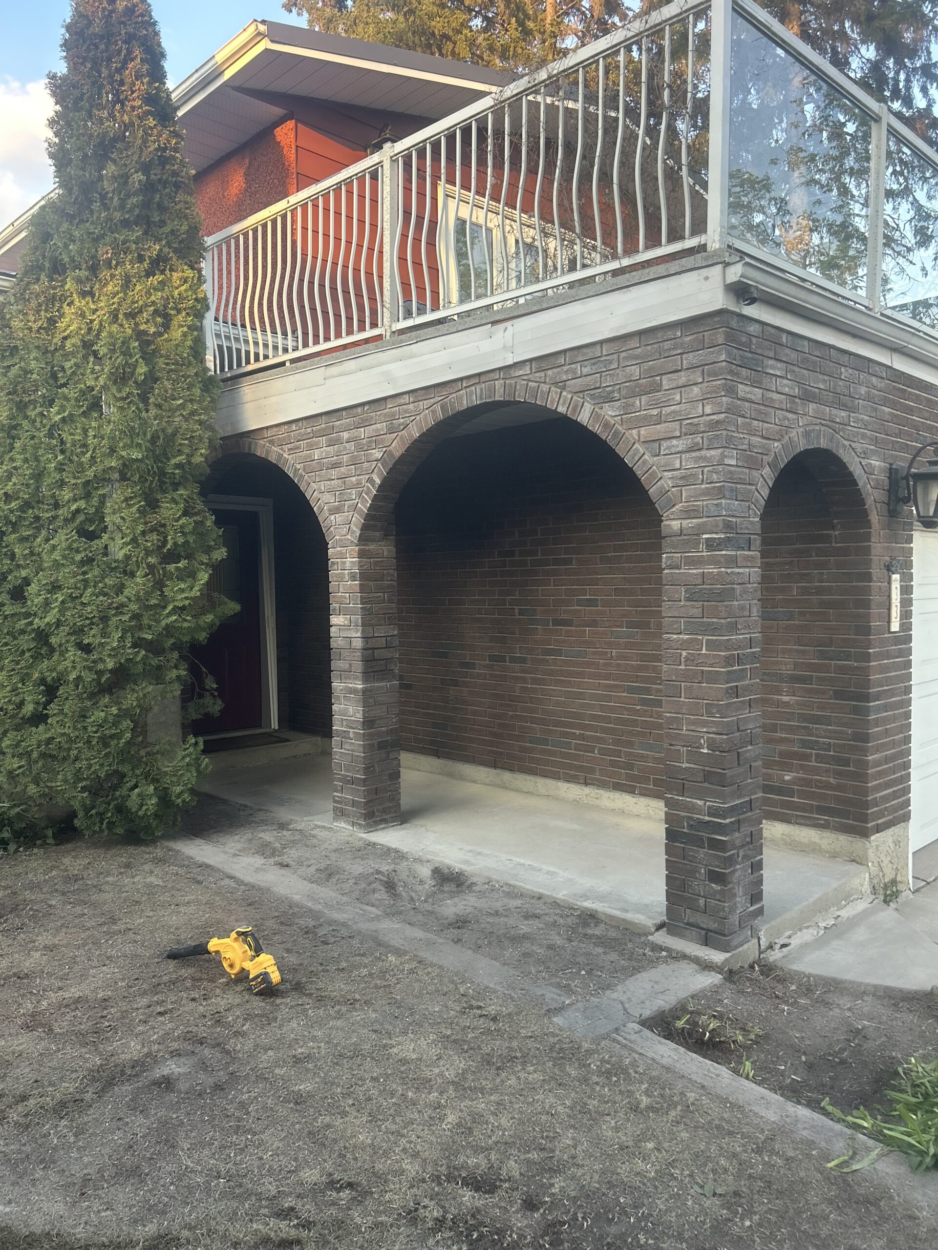 Completed residential entrance with restored brick masonry arches and columns